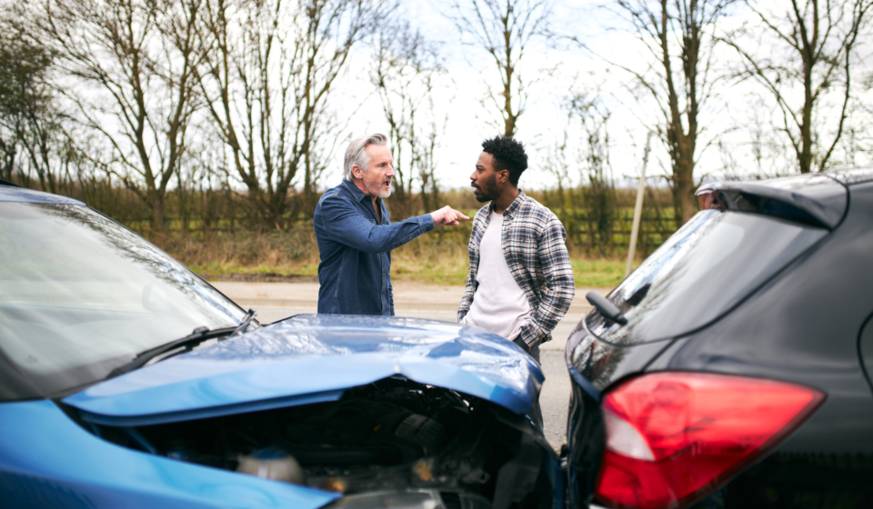 Senior Male Driver Arguing Over Blame For Car Accident With A Younger Male Motorist