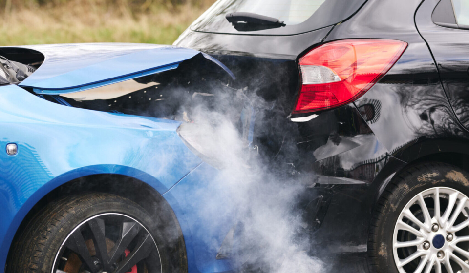 Two Damaged Cars Involved In Road Traffic Accident Showing Smoke After Collision